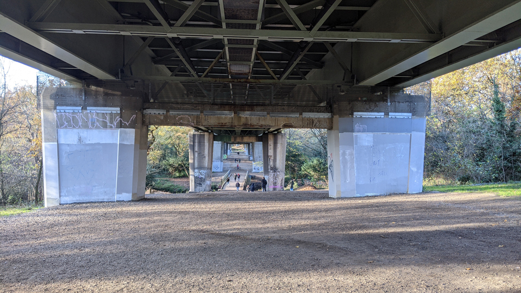 A path runs underneath the M4 motorway, letting people walk and ride-bikes between the pillars which hold the road aloft.