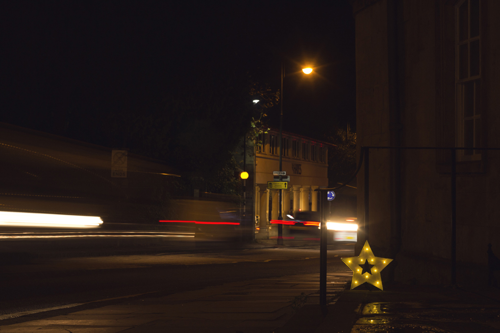 A Christmas star set against a long exposure of evening traffic on the Paragon in Bath.