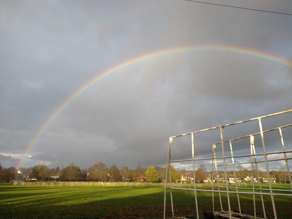 A rainbow over a village common