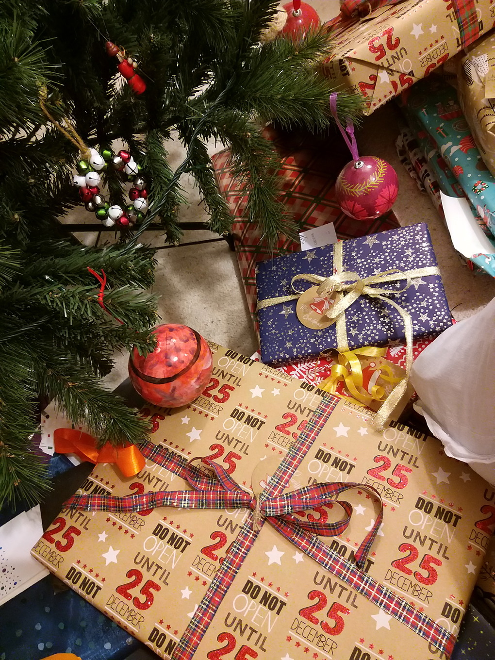 Presents arranged around the bottom of the Christmas tree