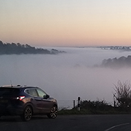 Hill tops jutting out of a sea of mist.  Picture taken from the top of one of the hill tops.