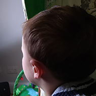 boy watching TV in an indoor tepee