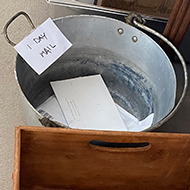 Mail being moved between three boxes after delivery each day before opening, to avoid possible infection from new mail