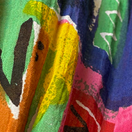 Close-up of fabric showing multicoloured letters