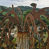A beautiful sculpture of a weeping willow tree made of copper and other metal. It stands on a high point in a beautifully laid out cemetery with a lovely view of the countryside. Its leaves each have the name of a person to be remembered. I took this photo as a memorial for all those who have died of The Corona Virus throughout this awful and strange year.