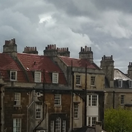Rows of houses viewed from the back through a window.