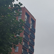 view between two high rise blocks of flats on a grey misty day