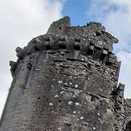 Castle with moat in the sunlight.