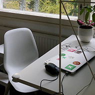 Shelves and a desk in front of a window.