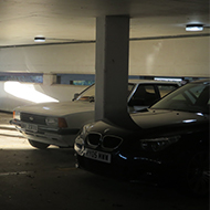 A shaft of late Autumn sunlight brightly illuminates a spot in an a below ground car park in St Martins car park Dorking