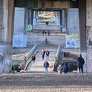 A path runs underneath the M4 motorway, letting people walk and ride-bikes between the pillars which hold the road aloft.