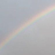 A rainbow over a village common