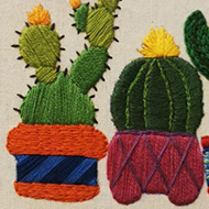sewing depiction of cactuses reading 