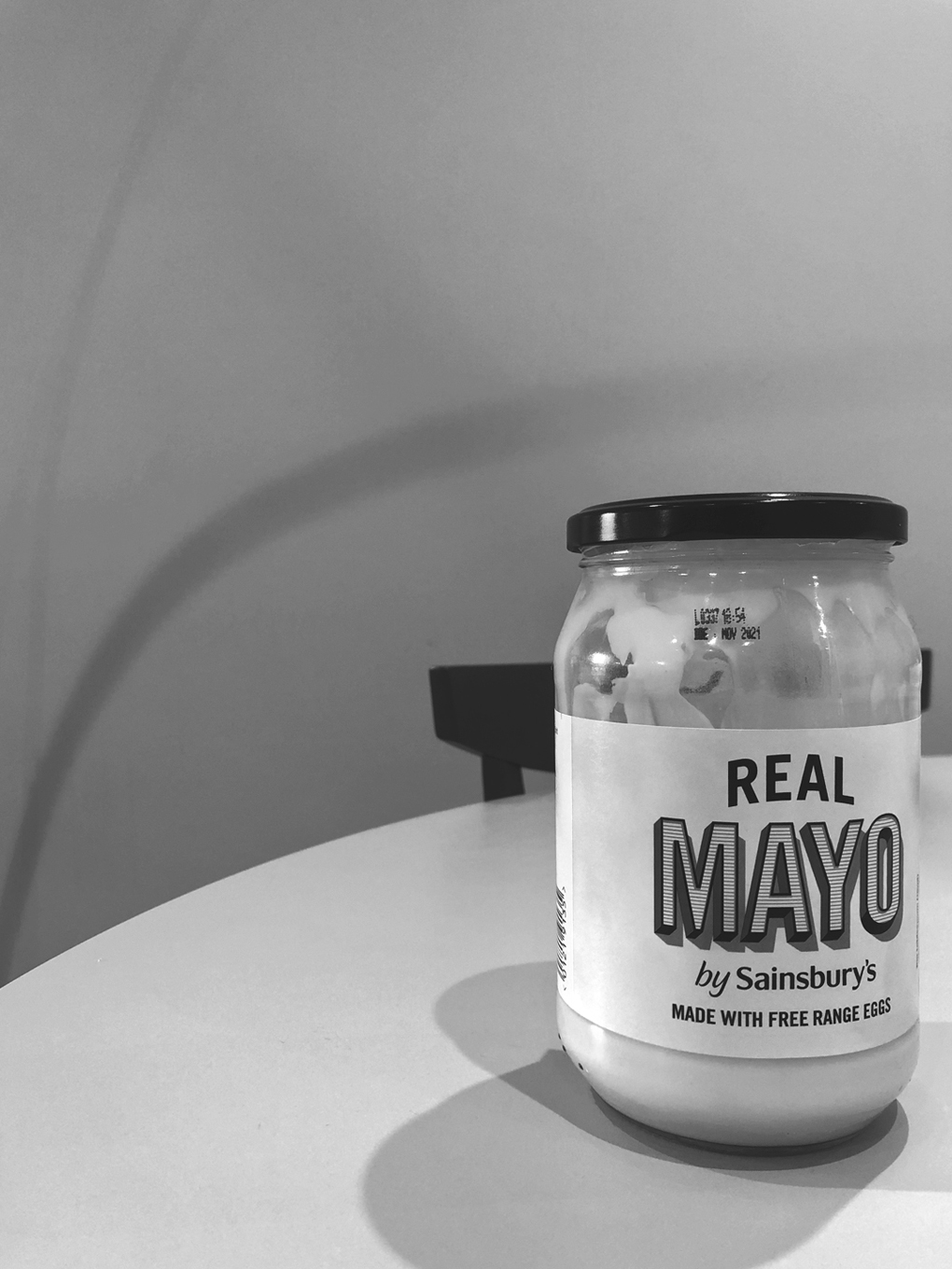 A jar of Sainsbury's mayonnaise in black and white.