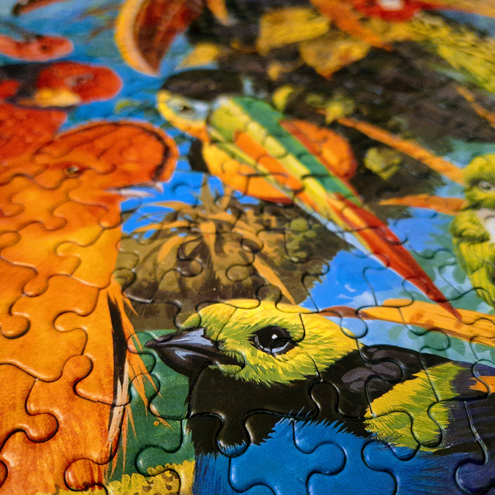 A close up shot of a jigsaw puzzle of a bird surrounded by foliage.