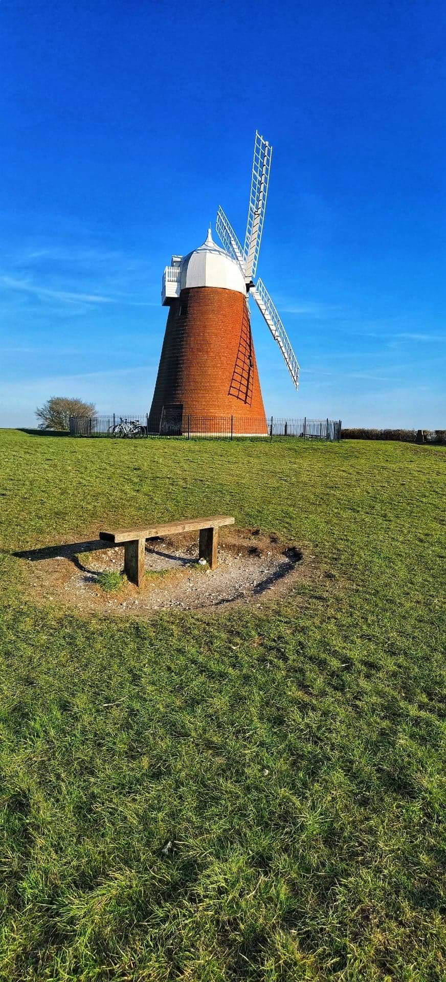 Windmill and bench on a hill