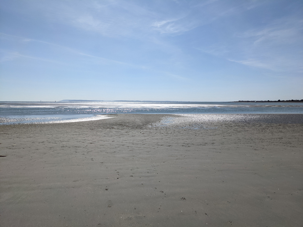 sunlight on sea and sand making a silver effect