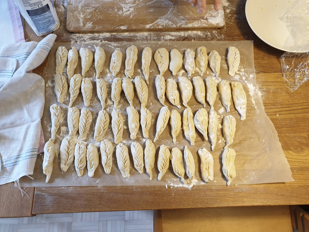 Homemade ravioli laid out on the table waiting to be cooked.