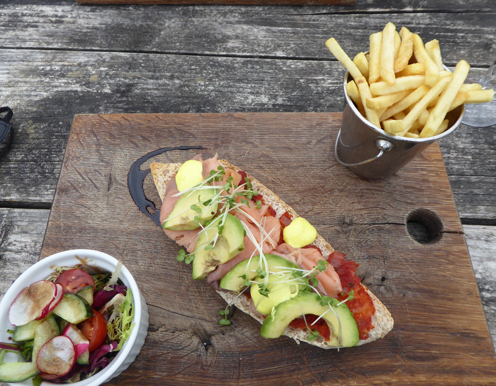 Platter of food with open sandwich, little salad and fries