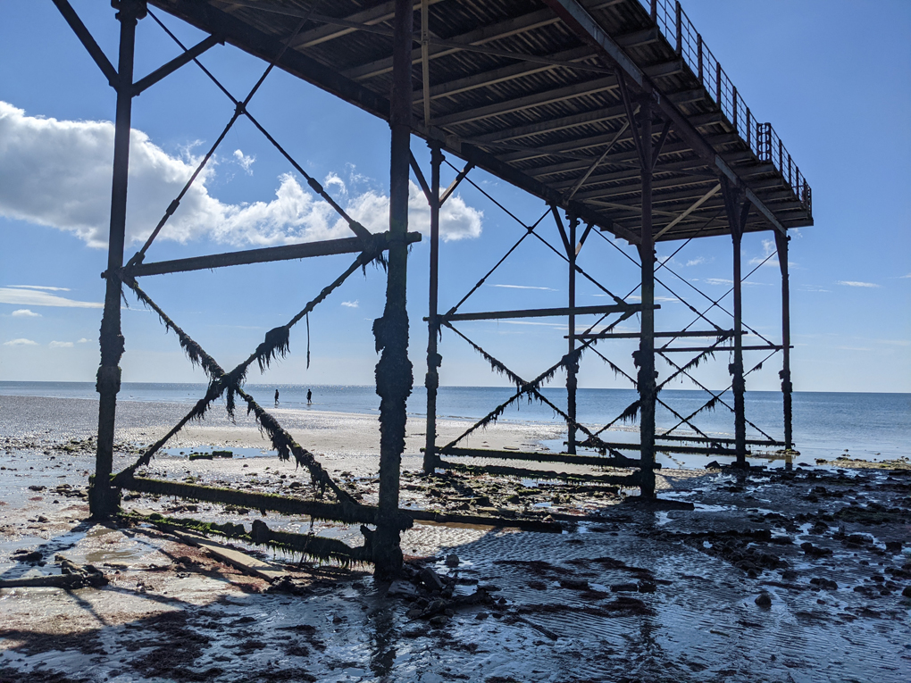 View looking out to see at low tide from under the pier