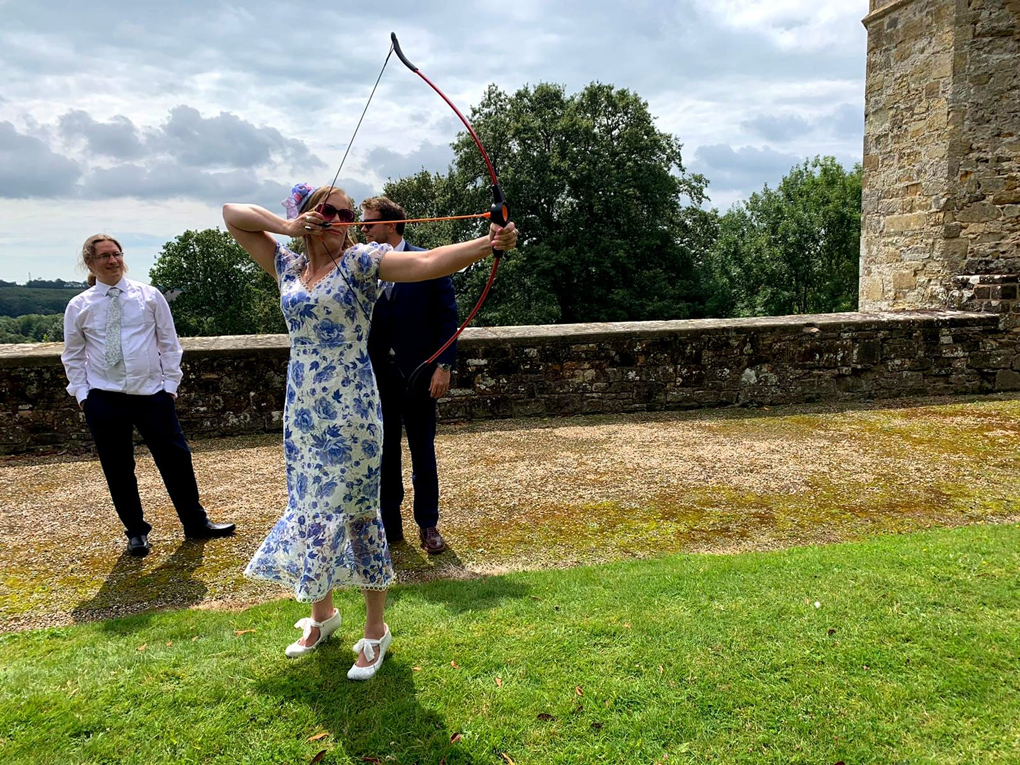 lady dressed up drawing a bow