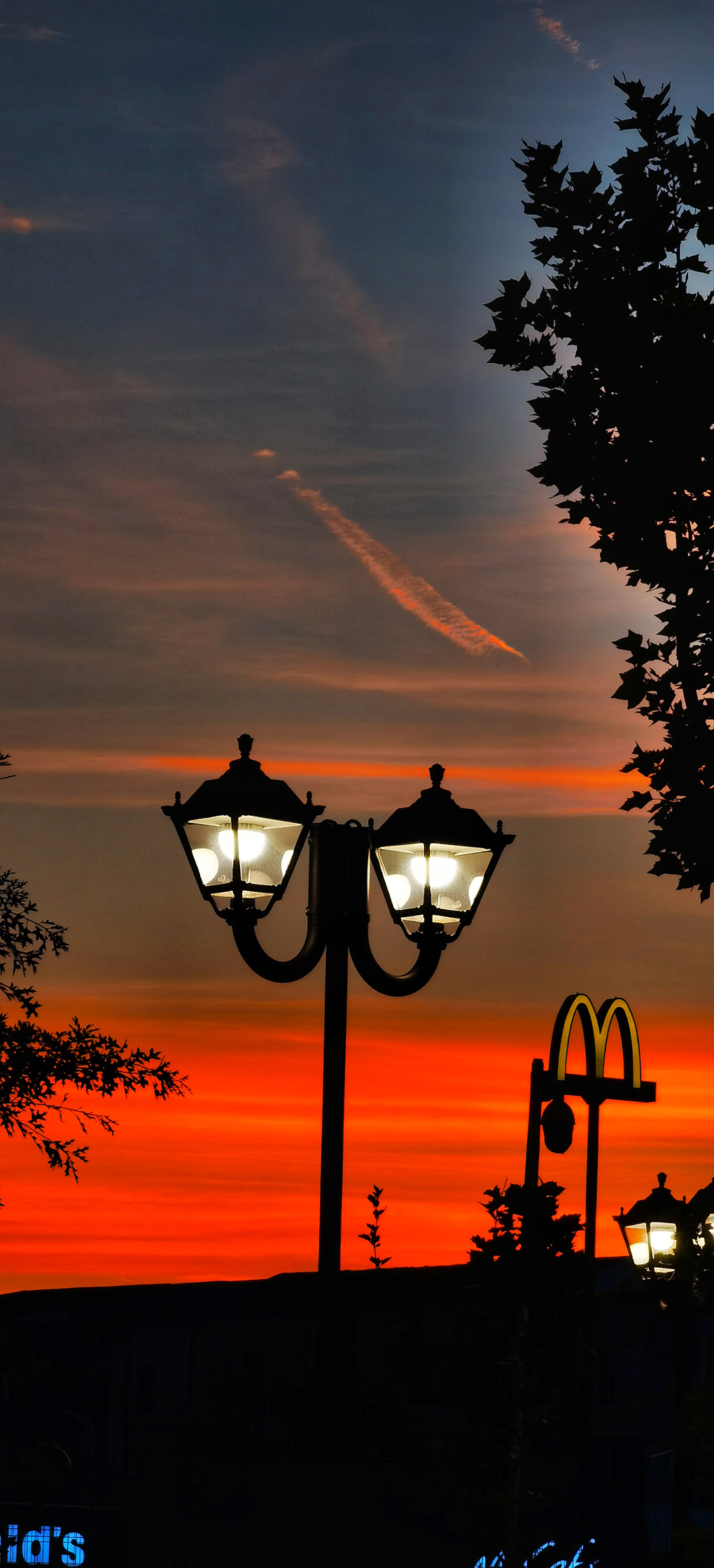 Lamp posts and McDonalds sign in a sunset