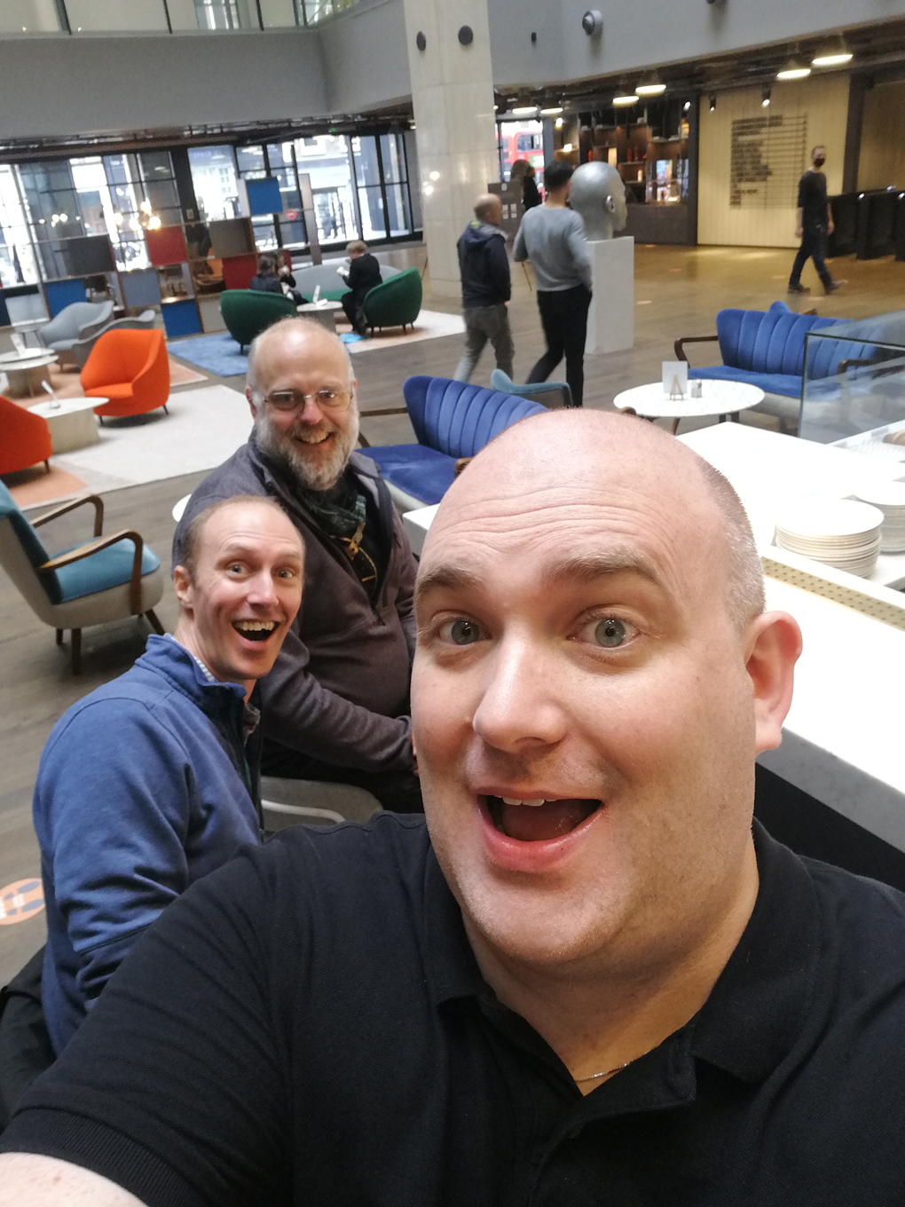 Me and two men sitting at a coffee bar in an office building