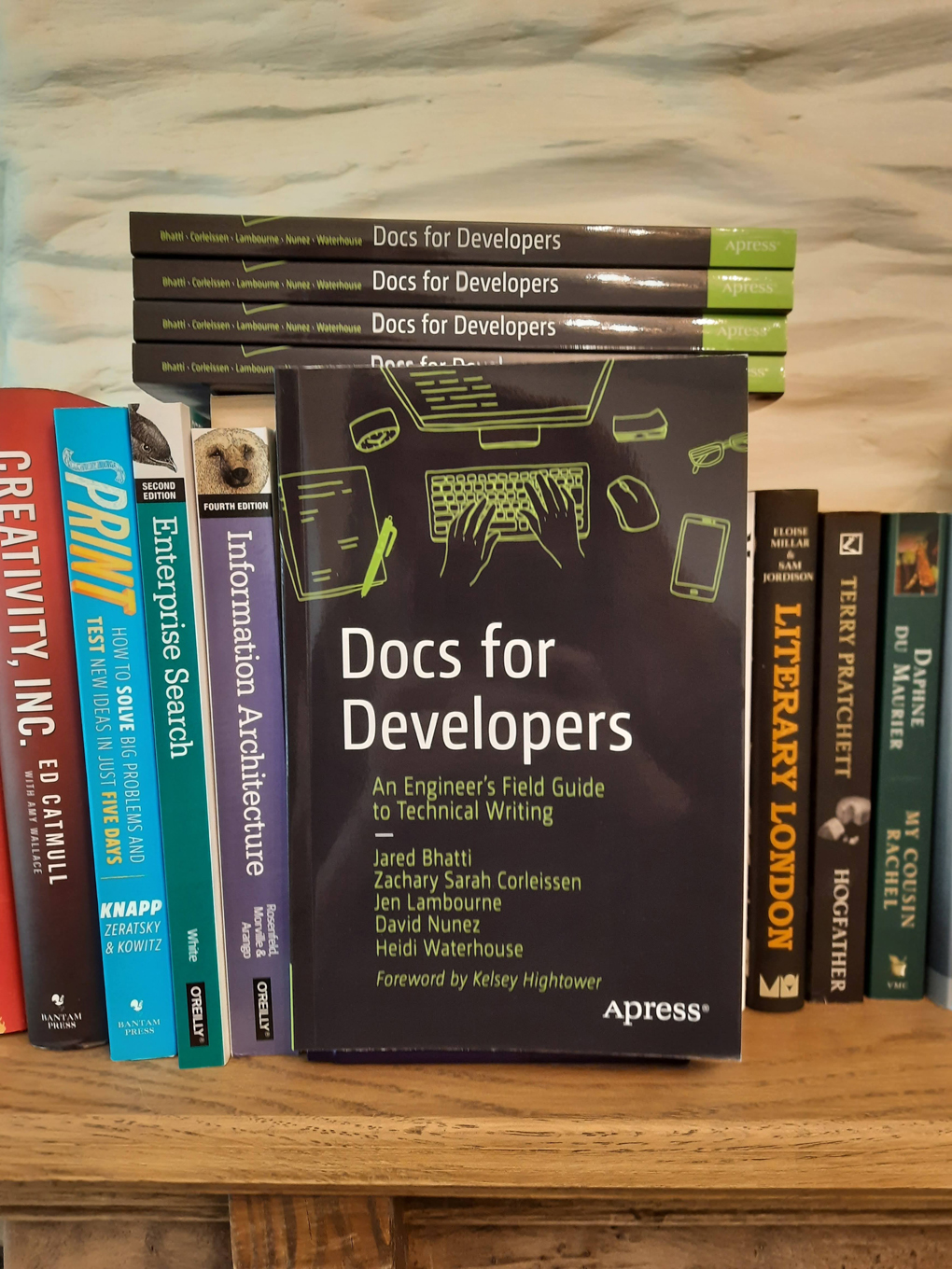 A stack of books titled 'Docs for Developers: An engineer's field guide to technical writing' on a bookshelf