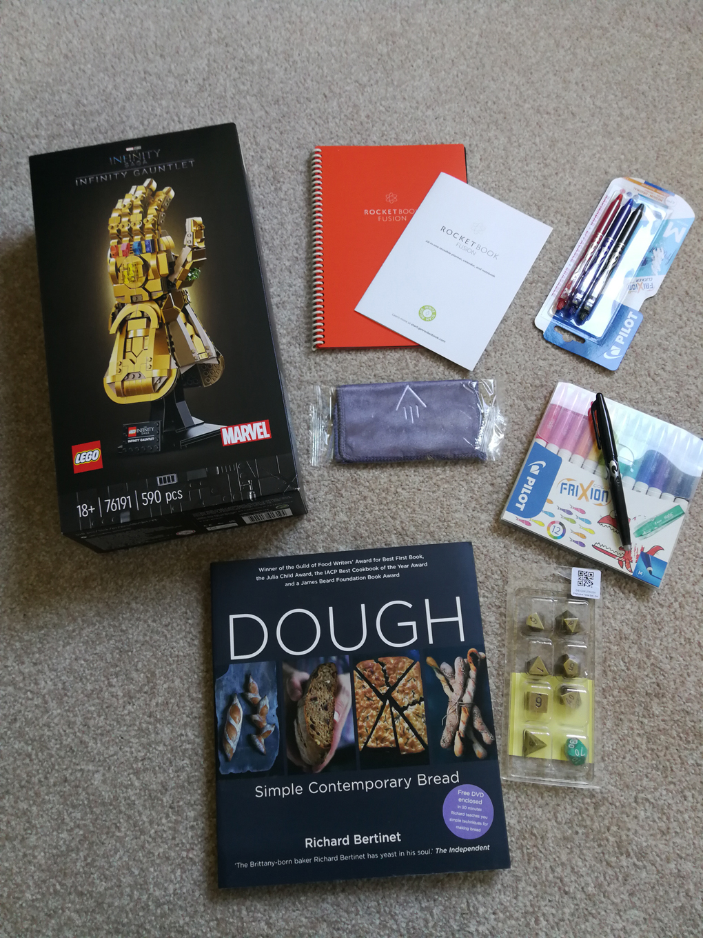 Collection of presents - LEGO Infinity Gauntlet, Baking book, Brass dice, wipe-clean notepad and pens