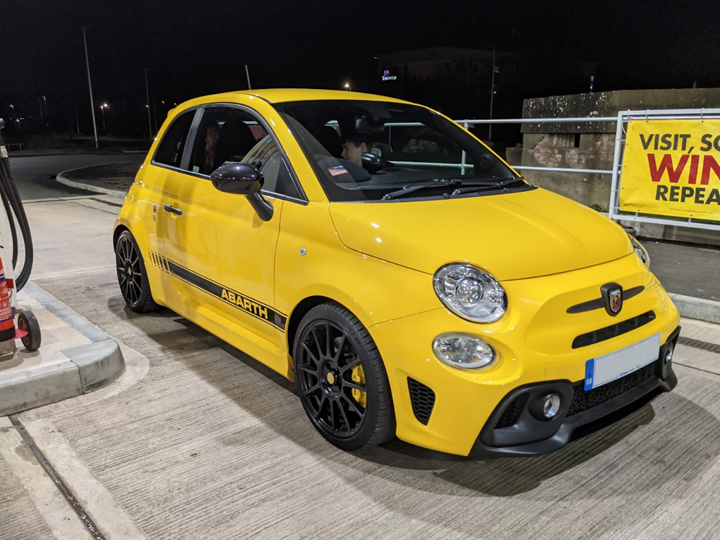 A bright yellow Abarth 595 Competizione on 17
