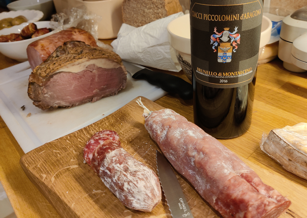 Cold meats, Christmas lunch leftovers and red wine ready to be served for a Boxing day meal