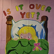 A billboard poster which features a small child looking scared in bed and the caption 