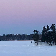 Snowy landscape and a light pink sky.