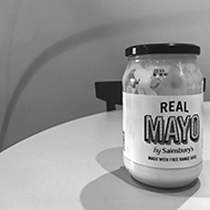 A jar of Sainsbury's mayonnaise in black and white.
