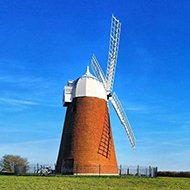 Windmill and bench on a hill