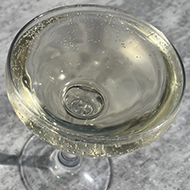 Champagne coupes on a marble table in the sun