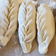 Homemade ravioli laid out on the table waiting to be cooked.