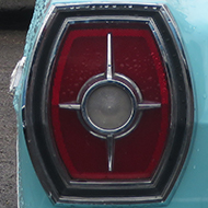 We see a '65 Ford Galaxie 500 convertible on right hand side of the picture parked next to some friends - A mid -90s Lincoln Town Car (beige), front wing of a '56 T bird (blue), rear of a '59 Plymouth wagon (light green) , '59 Ford Skyliner in the background (coral).