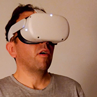 Man wearing a VR headset and an expression of wonder