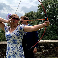 lady dressed up drawing a bow