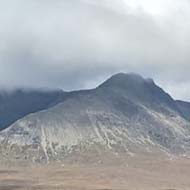 A view of the ocean, beach and mountains of Skye.