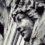 Stone head on arch on building in Bucharest