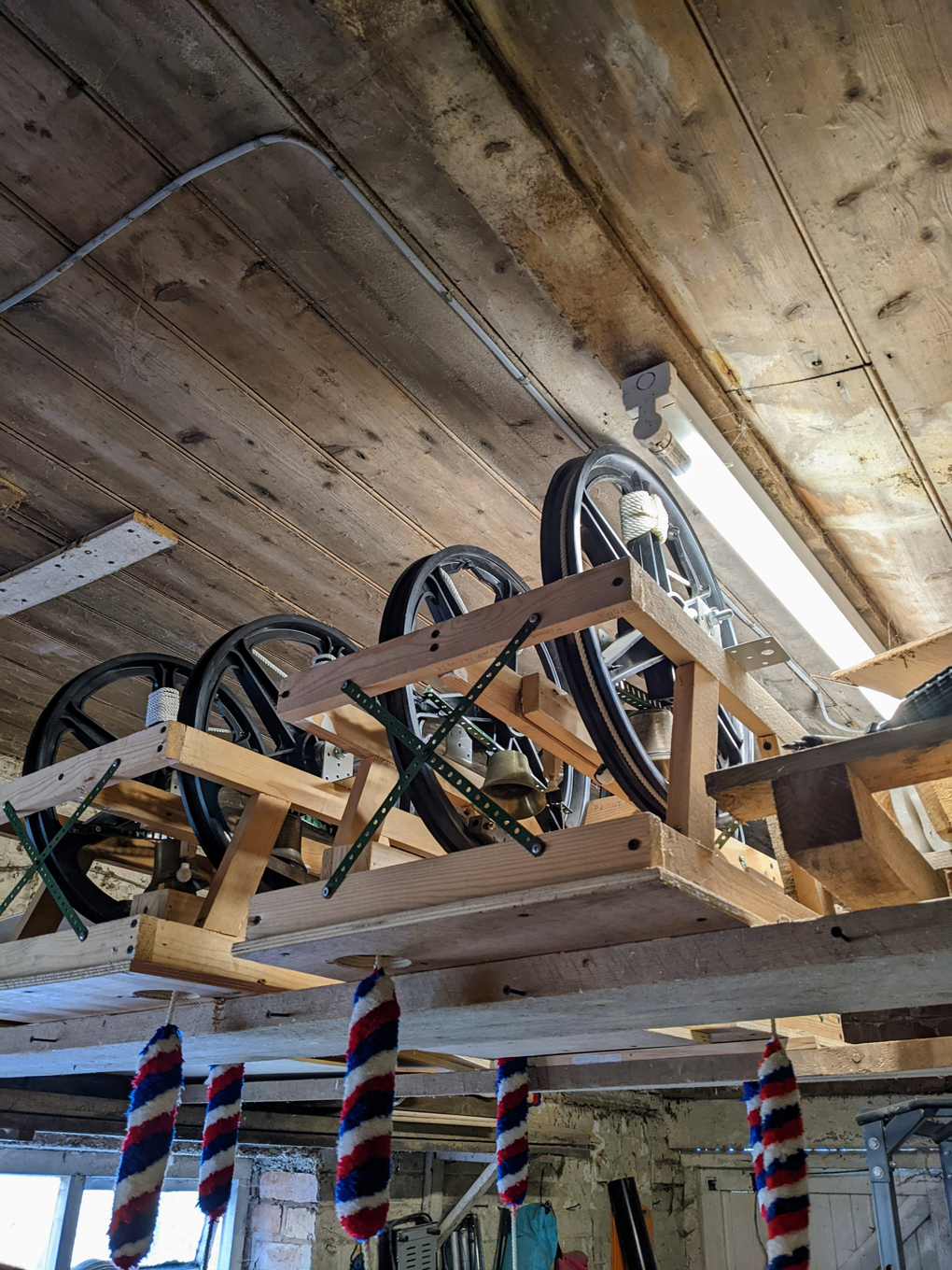 Picture of very small bells hung in a workshop.