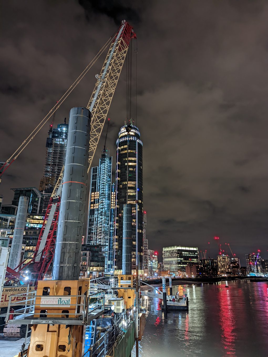 London high-rise buildings along the Thames, lit up at night