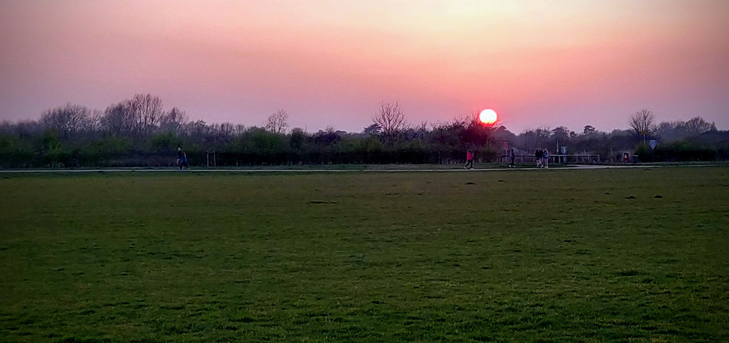 Photo of the sun going down as we walk around the track not far from the house.