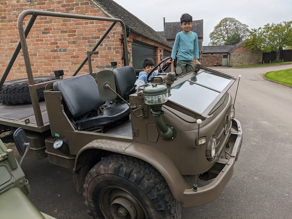 Boys sitting in a ex-Swiss Army Reserves Unimog off-road vehicle in Brailsford