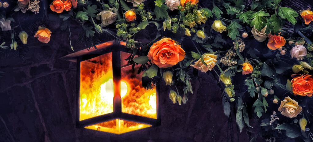 Church porch light surrounded by Easter flowers.