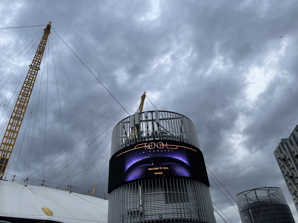 O2 arena with sign advertising a concert for the band Tool, grey skies in the background
