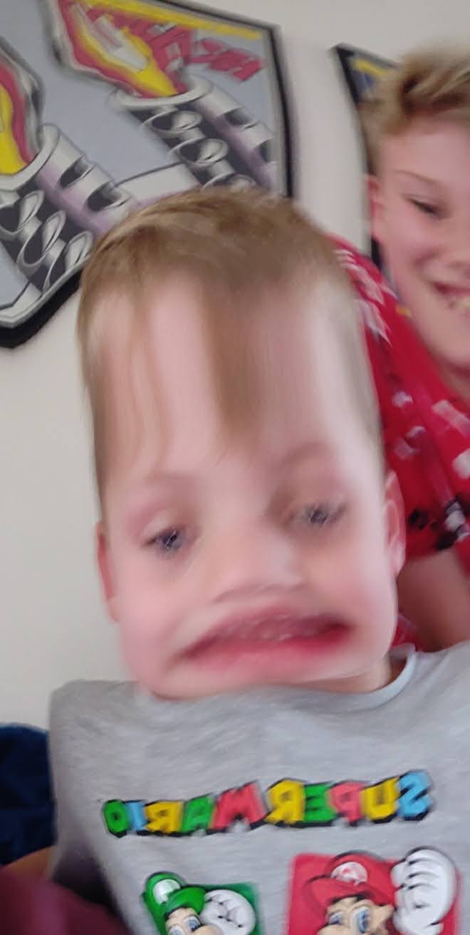 My Son Jack with a stretched face, Josh in the background laughing at the Snap Chat filter they have selected.