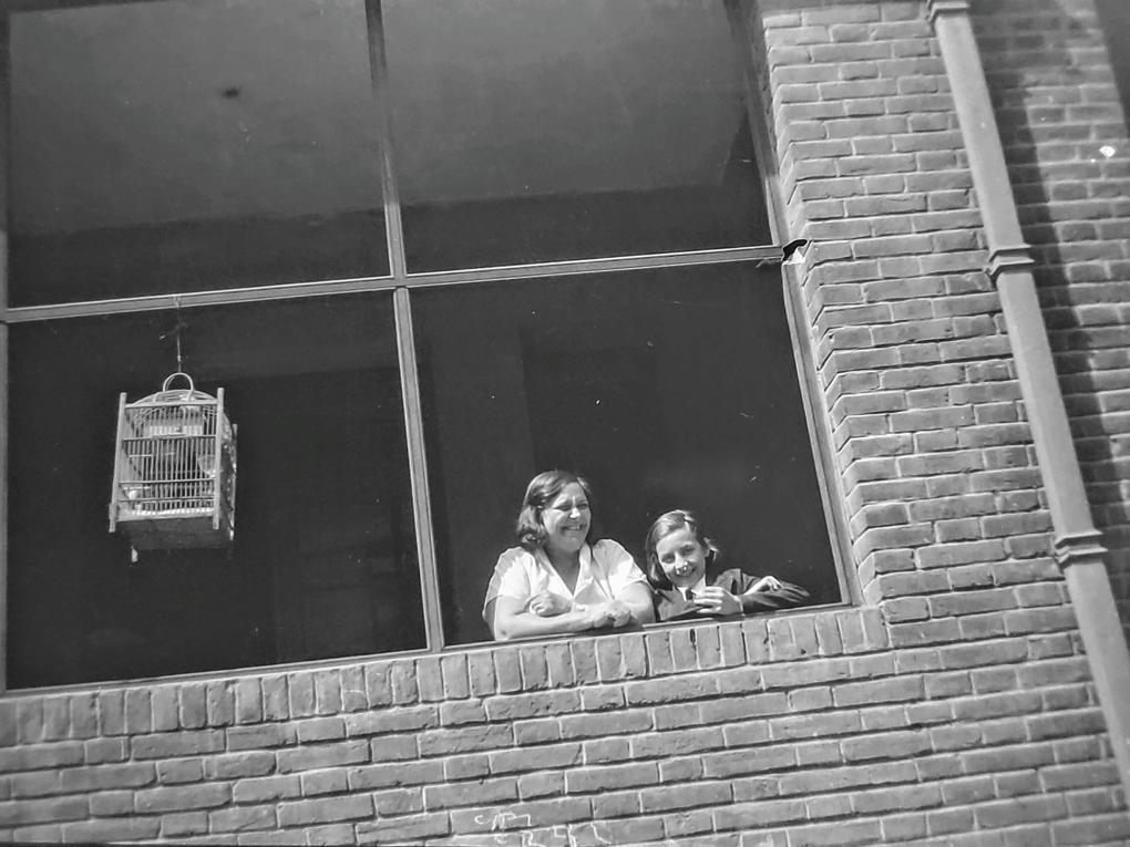 Black and white image of 2 people looking out a window, my grandmother and great-grandmother